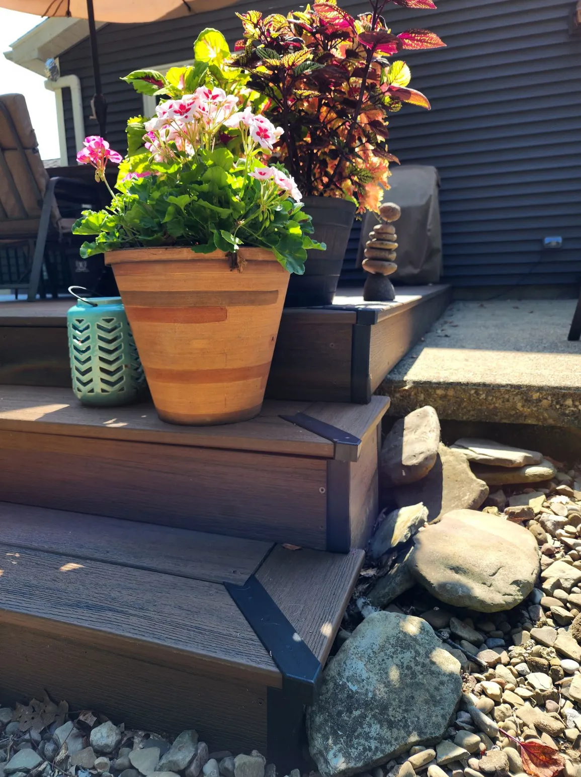 Finished deck steps with capped, mitered corners on a backyard deck